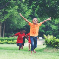 Group Of Young Children Running and playing in the park